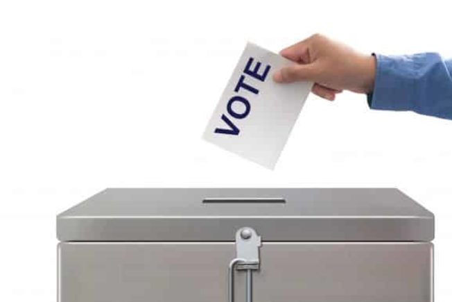 hand-putting-voting-paper-elections-and-concept-democratie_51195-3364